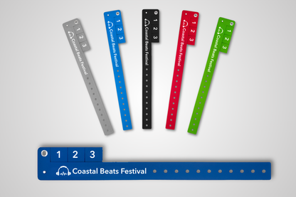 A photo of entrance wristbands with detachable tickets in different colors